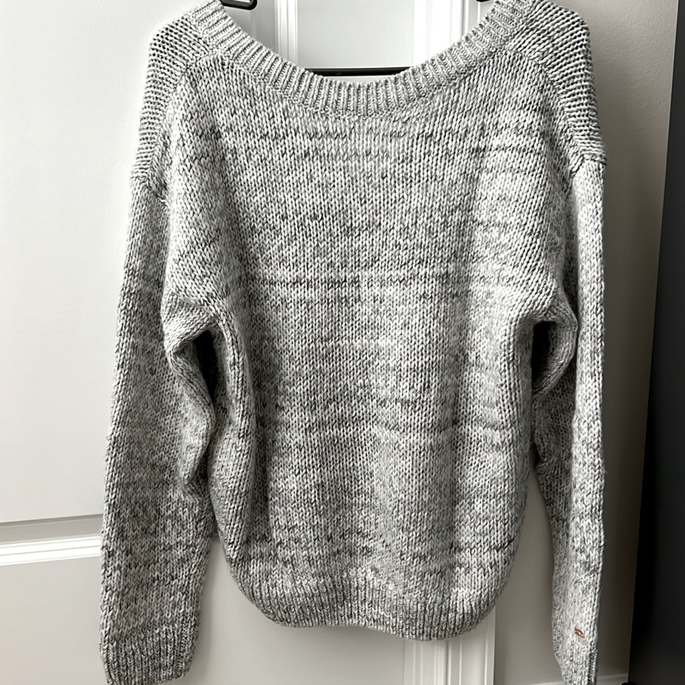Knit sweater. Can be worn with the v neck in the front or back